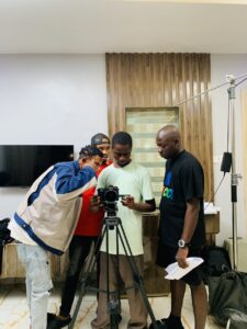 Godwin Harrison (in black) on set