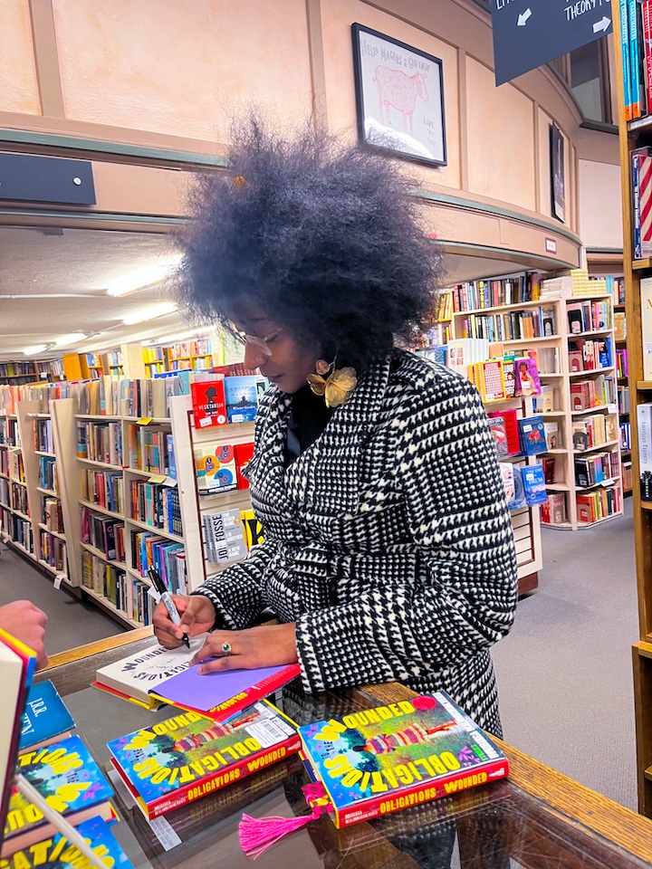 Mubanga Kalimamukwento at a book signing event for Obligations to the Wounded.